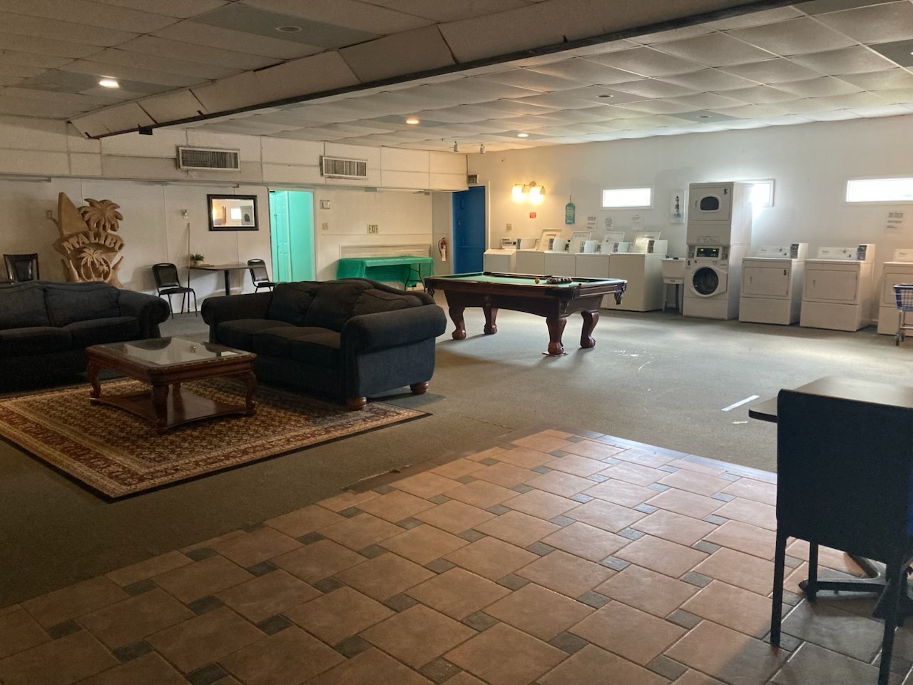 On-site laundry room and lounge with a pool table at Windswept RV Park